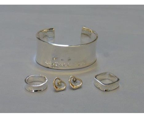 A selection of silver jewellery comprising a bangle, two rings and a pair of earrings, the bangle marked 1997, Tiffany & Co. 