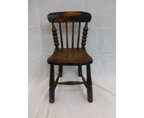 A 19th Century ash and elm child's chair with traces of original paint and unusually with bobbin turned uprights. 