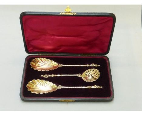 A cased set of three silver gilt spoons, a sugar sifter and two serving spoons maker William Hutton & Sons Ltd. London 1901 a