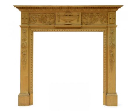 A STRIPPED PINE CHIMNEYPIECE IN NEOCLASSICAL STYLE, 125CM H, SHELF 141CM W, A BLACK PAINTED WROUGHT IRON FIRE GRATE AND FIRE 