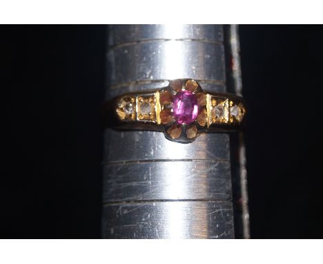 22 carat gold ring set with four diamonds to the shoulders flanking central ruby, size N 