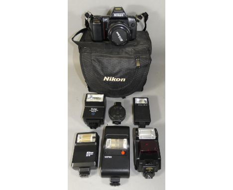 A cased Nikon AF F-801 camera, with AF Nikkor 35-70mm 1:3.3-4.5 lens, together with a carry case full of Nikon accessories in