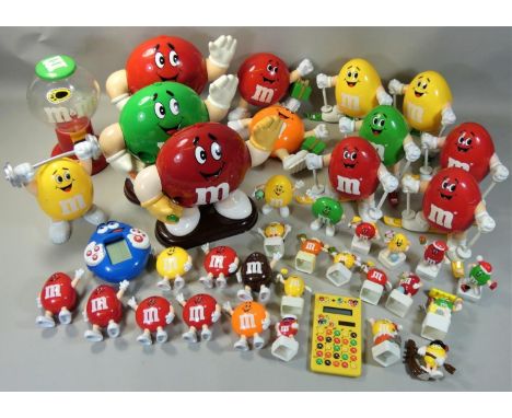 A large collection of M&amp;M figures in two boxes, c.1990, to include a very large sweet dispenser, red figure with yellow g