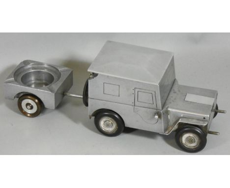A German made c1948 cigarette table lighter in the form of a Willys Jeep, hinged lid for cigarettes and ashtray in the traile