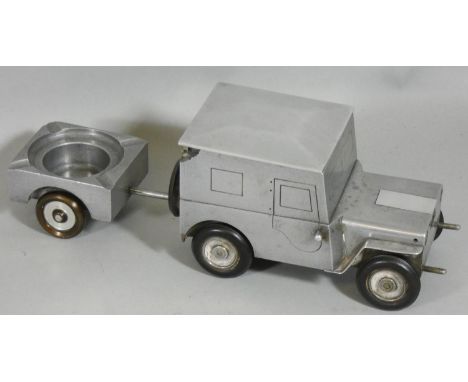 A German made c1948 cigarette table lighter in the form of a Willys Jeep, hinged lid for cigarettes and ashtray in the traile