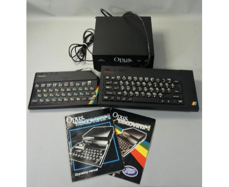 An Opus Discovery 1 video game console and manual, together with a ZX Spectrum 48K and a Spectrum +1, both connected with a f