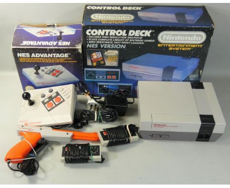 A boxed Nintendo Entertainment System Control Deck, together with a boxed NES Advantage and a NES Zapper light sensing video 