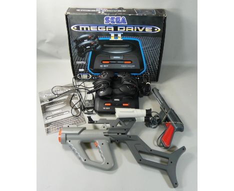 A boxed Sega Mega Drive II 16-Bit video game console, together with a box of accessories including a Sega Menacer light gun a
