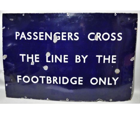 A vitreous enamel, single sided, wall mounted railway sign, 'Passengers cross the line by the footbridge only', 61 x 91cm. 