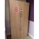 Wooden 4 door storage cupboard with quantity of glassware and crockery
