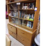 4 drawer wooden cabinet with glass fronted display and large quantity of books