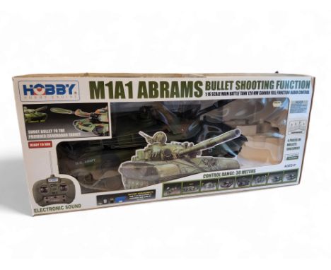 A Hobby Engine M1A1 Abrams Tank, with bullet shooting function, boxed, paperwork and RC controller present 