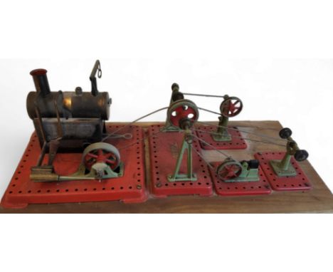 A Mamod stationary steam engine, with whistle, on base board with wire driven pulley sytem powering hammer, press and polishe
