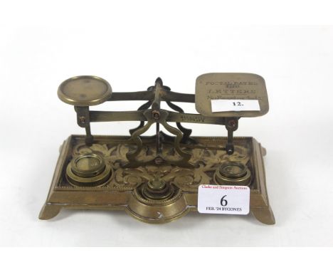 An ornate set of brass postal scales with part set of brass weights 'Not to Exceed 4oz'