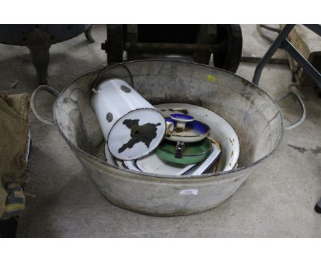 A galvanised twin handled bath AF and contents of enamel kitchenware, bowls etc.