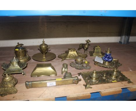 A quantity of brass inkwells of various shapes including sphinx, pineapple, and one blue and white ceramic and brass example 