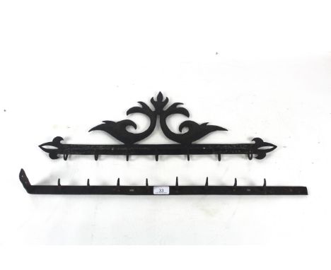 Two early 19th Century metal utensil racks, one plain and one with decorative pediments 