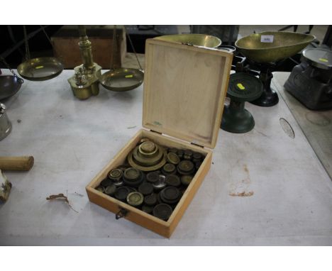 A box containing a large quantity of mainly Victorian brass scale weights, weighing a total of approximately 11lbs