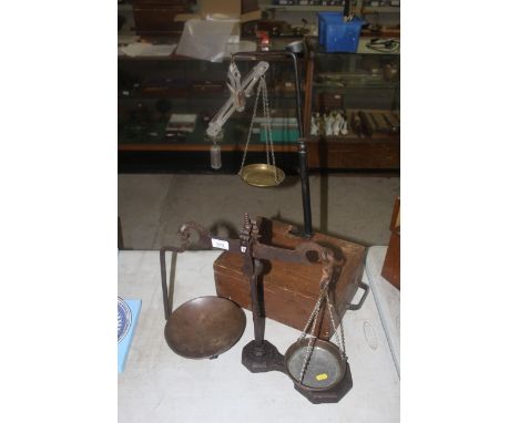 A set of cast iron balance scales with copper trays and a set of wooden and metal travellers weighing scales with brass pans