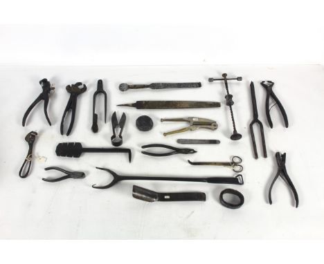 A box containing a Sawset scribe, pliers, punches and other tools
