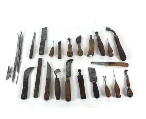 A box of shoe makers tools to include a counter knife, a blacking iron, a clickers knife etc.
