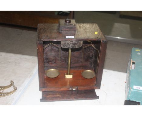 A travelling set of brass scales in wooden case with Bakelite light switch - sold as a collector's item 