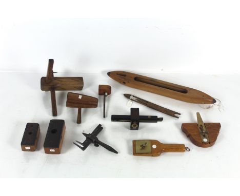 A box containing a bobbin, wooden workers markers, a dovetailing marking gauge, a further wooden marking gauge etc.