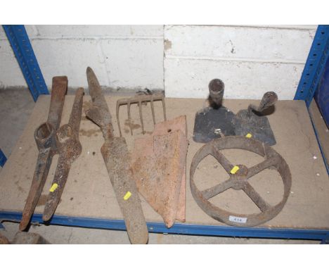 Two pick axe heads, a metal wheel, plough points etc.