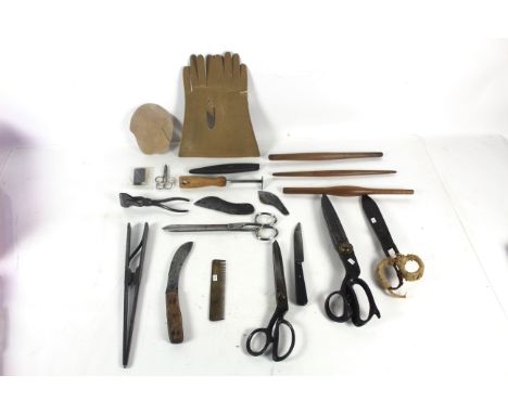 A quantity of glover's tools to include two large pairs of shears, Taylor's I'Witness finger stretchers, clamp, glove cards e