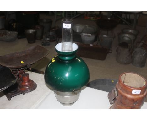 A Bialladin table oil lamp with green glass shade 