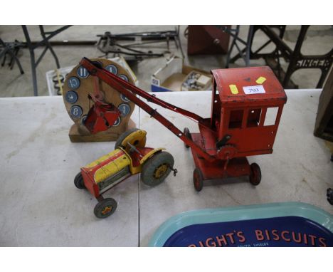 A child's tin plate toy crane, tin plate tractor  and a child's wooden learning clock 