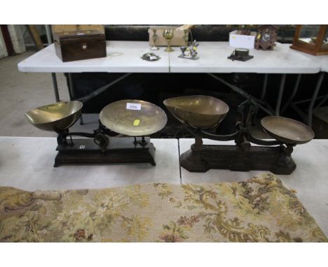 Two sets of domestic balance scales with brass trays