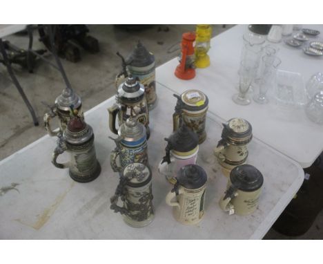 Eleven various decorative ceramic Steins with lids 