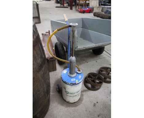 A BP Self Mix Oil dispenser for 2 stroke engines on trolley base