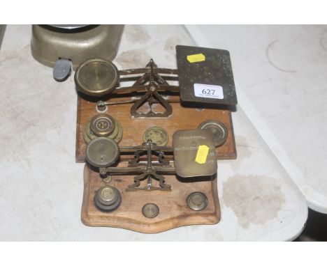 Two small sets of brass postal scales with a small collection of brass weights 
