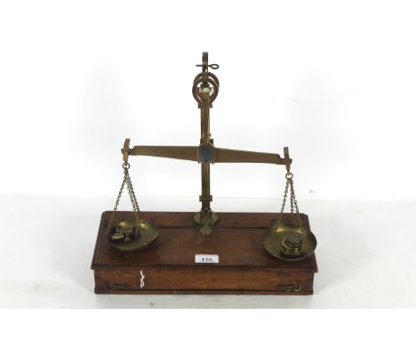 A travelling brass set of balance scales with box base to weigh 1lb with various weights