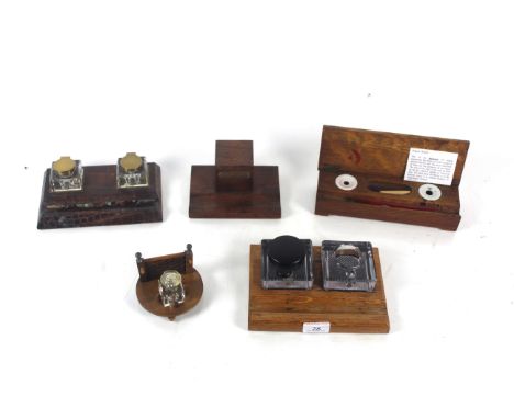A small wooden based inkwell with fence motif to the rear and glass inkwell, a crocodile skin ink and pen stand with a pair o
