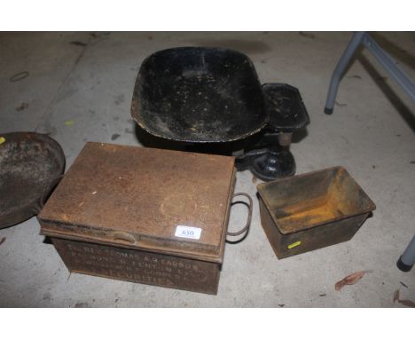 A set of shop scales, a tin box with two handles and a baking tray