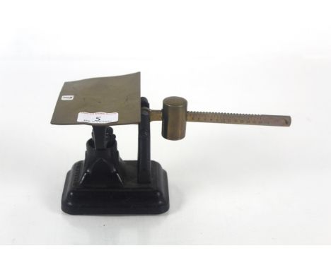 A set of unusual small cast iron and brass postage scales 