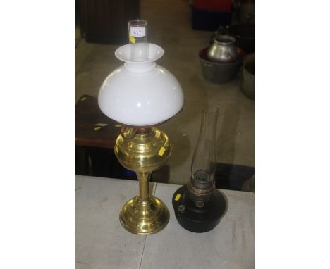 A brass oil lamp with opaque glass shade and a further small oil lamp 