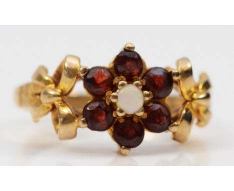 A 9ct gold vintage garnet and opal dress ring with patterned shoulders, Birmingham 1978, M 1/2, 3.4g 