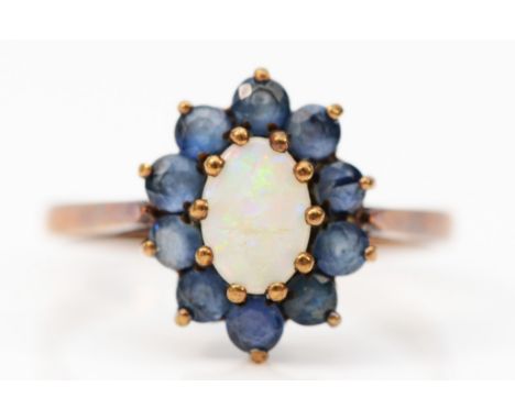 A 9ct gold vintage opal and sapphire cluster ring, claw set, London 1972, N, 2.3g 
