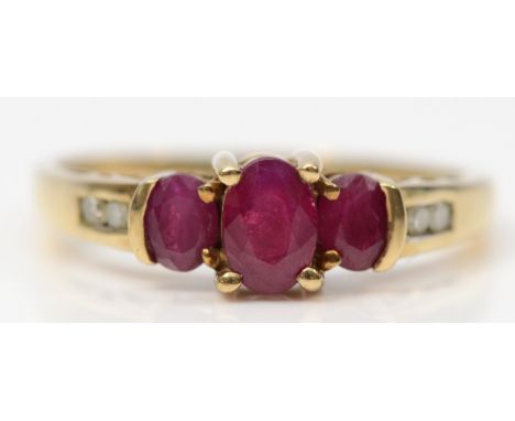 A 9ct gold oval cut ruby and diamond dress ring, O 1/2, 2g 