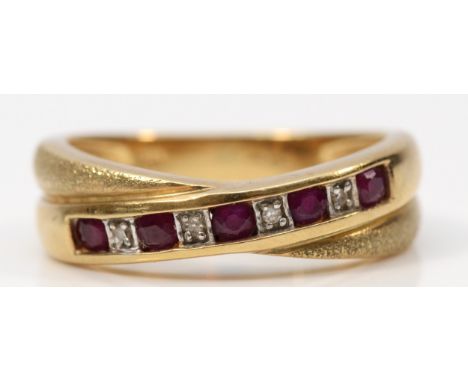 A 9ct gold ruby and diamond crossover ring, N, 3.3g 