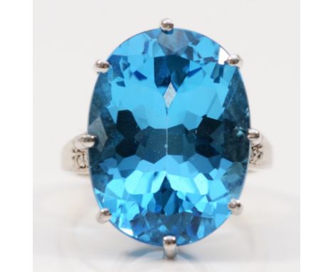 A 9ct white gold oval cut blue topaz dress ring with diamond shoulders, 20mm x15mm topaz,  N 1/2, 9.1g 