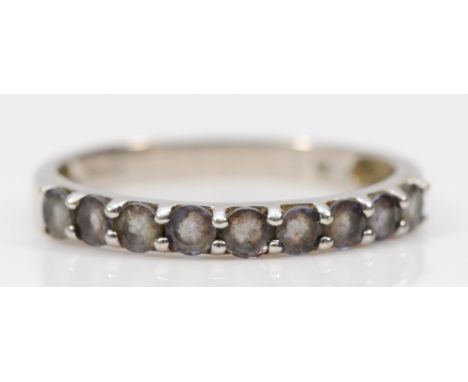 A 9ct white gold tanzanite half eternity ring, claw set, N 1/2, 1.5g 