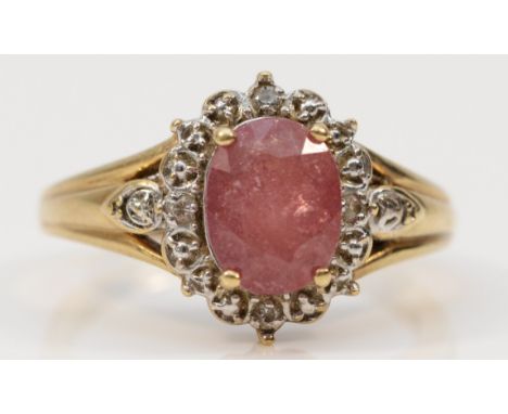 A 9ct gold oval cut ruby and diamond cluster ring, R, 4g 