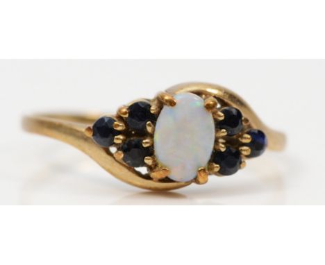 A 9ct gold vintage opal and sapphire dress ring, K 1/2, 1.2g 