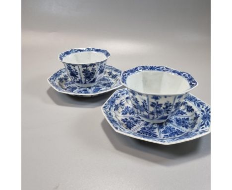 Pair of Chinese blue and white octagonal tea bowls and saucers, decorated to the front and reverse with panels of flowers and