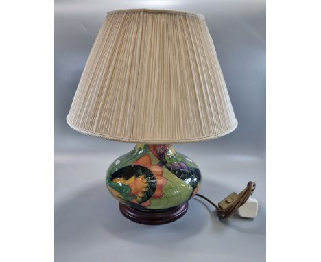 Modern Moorcroft tube-lined Carp design table lamp, of baluster form, standing on a wooden base. The lamp only 23cm high appr